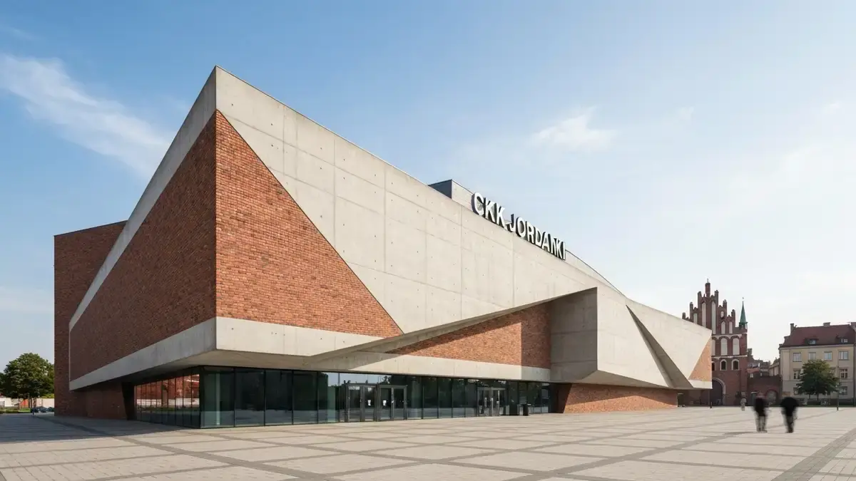 CKK Jordanki w Toruniu przy parku, z nowoczesną fasadą i gotyckim tłem miasta